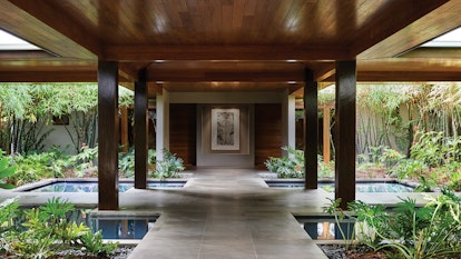 Spa qualia sheltered entrance with four pillars, garden and water features